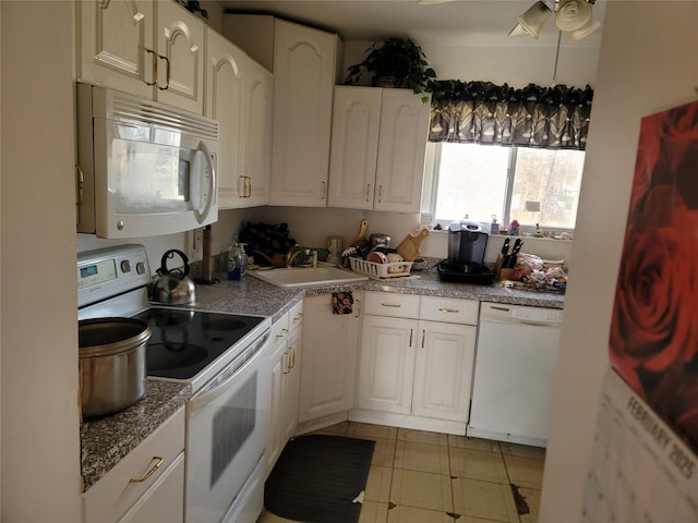 kitchen with white appliances, a sink, a ceiling fan, and white cabinets