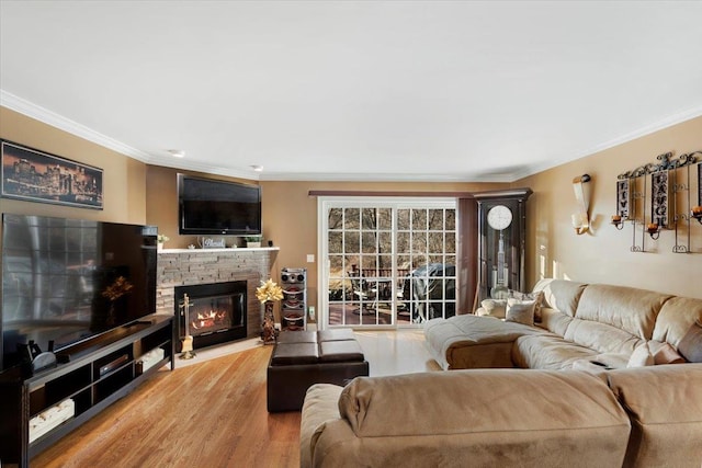 living room featuring hardwood / wood-style floors, a fireplace, and ornamental molding