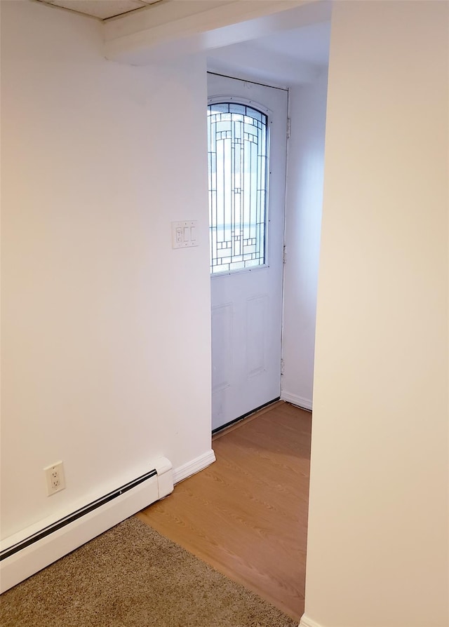 entryway featuring baseboard heating and hardwood / wood-style flooring