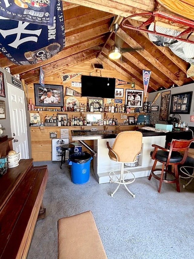 bar featuring wooden walls and vaulted ceiling