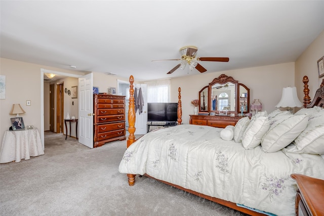 bedroom with ceiling fan and light carpet