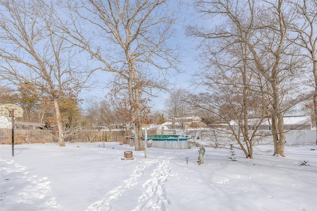 snowy yard with a covered pool