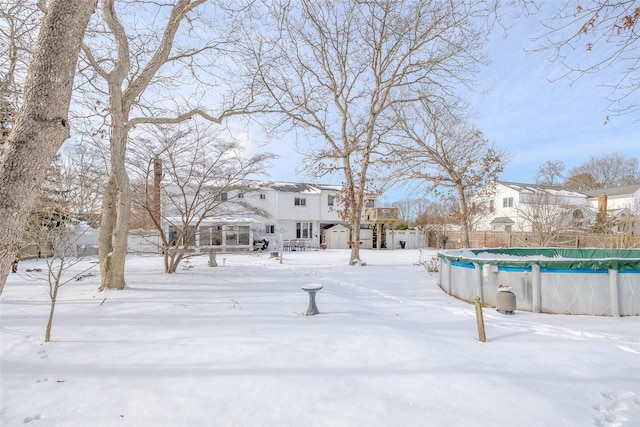 snowy yard with a covered pool