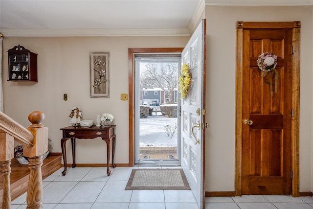 foyer entrance featuring crown molding and light tile patterned floors