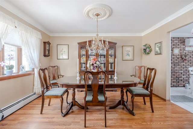 dining area with ornamental molding, a baseboard heating unit, a chandelier, and light wood-type flooring