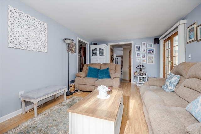 living room featuring french doors and light hardwood / wood-style flooring