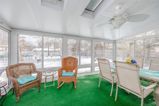 sunroom featuring vaulted ceiling and ceiling fan