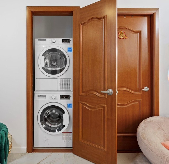 clothes washing area featuring stacked washer / drying machine