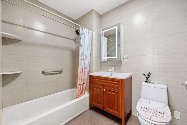 full bathroom featuring shower / bathtub combination with curtain, tile walls, vanity, and toilet