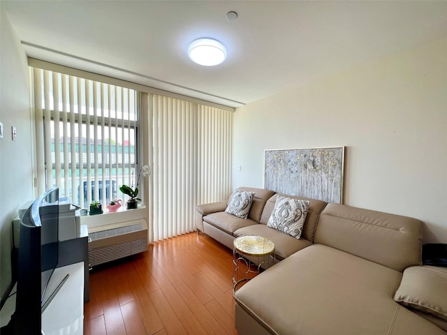 living room with radiator heating unit and hardwood / wood-style flooring