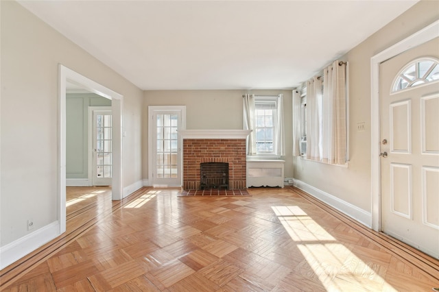 unfurnished living room featuring a fireplace and light parquet flooring