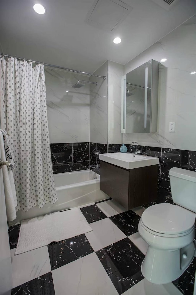 full bathroom featuring toilet, vanity, tile walls, and shower / bath combination with curtain