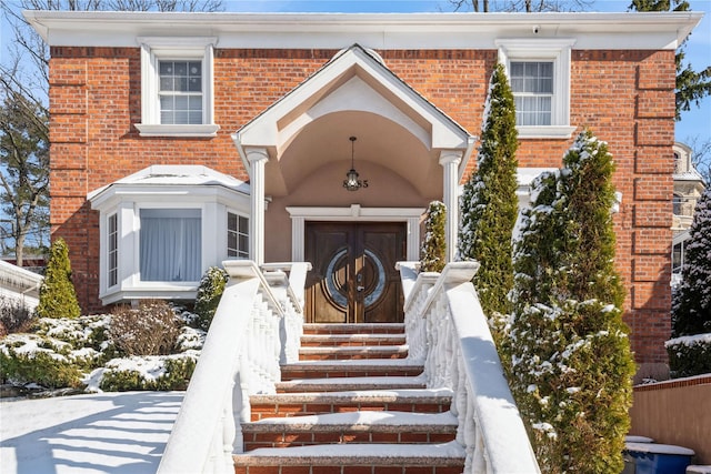 view of snow covered property entrance