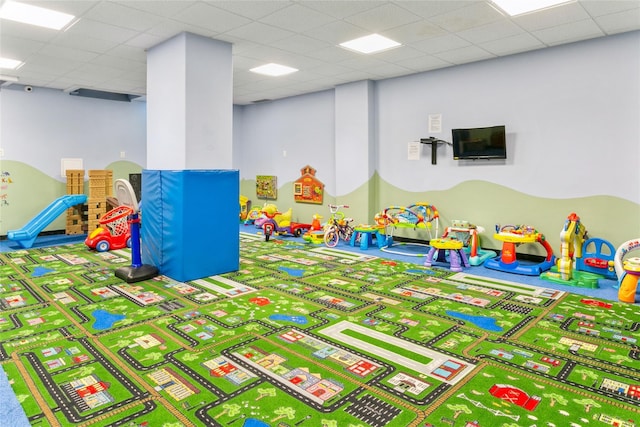 playroom featuring a paneled ceiling