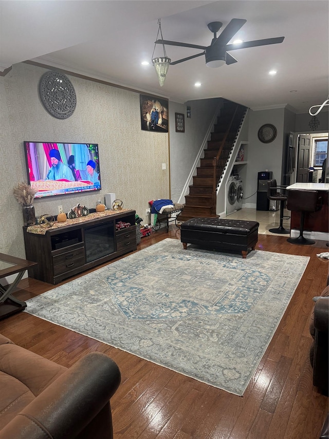 living room featuring hardwood / wood-style flooring, ceiling fan, and ornamental molding