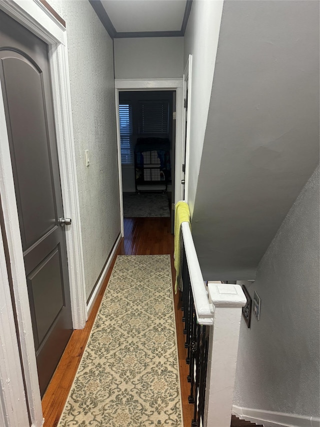 hall featuring ornamental molding and dark wood-type flooring