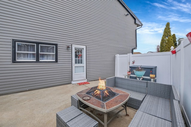 view of patio with an outdoor living space with a fire pit