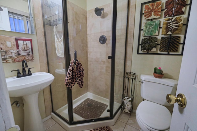 bathroom featuring walk in shower, sink, tile patterned floors, and toilet