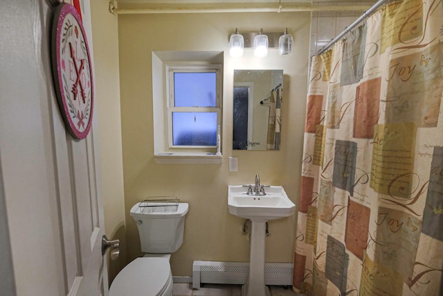 bathroom with toilet and baseboard heating