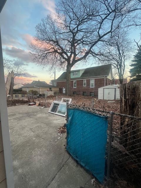 pool at dusk featuring a shed