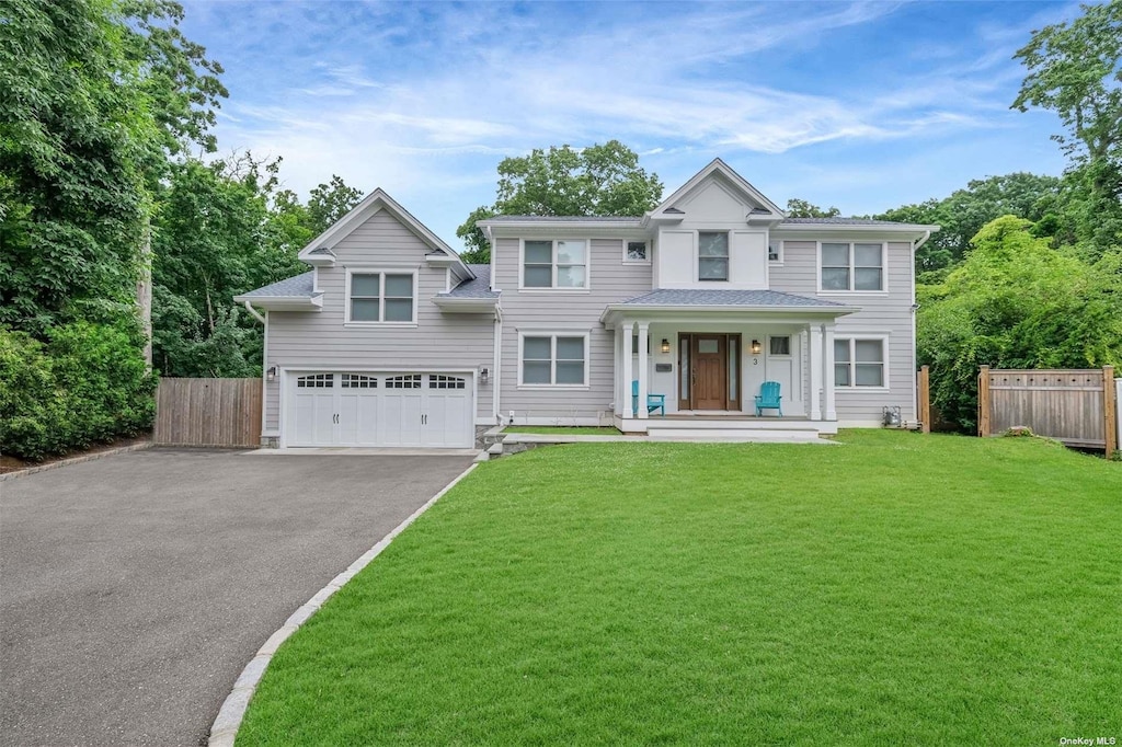 view of front of house with a front lawn and a garage