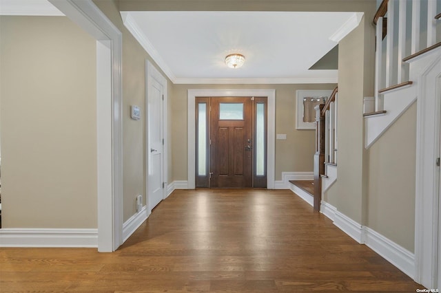 entryway with hardwood / wood-style flooring and crown molding