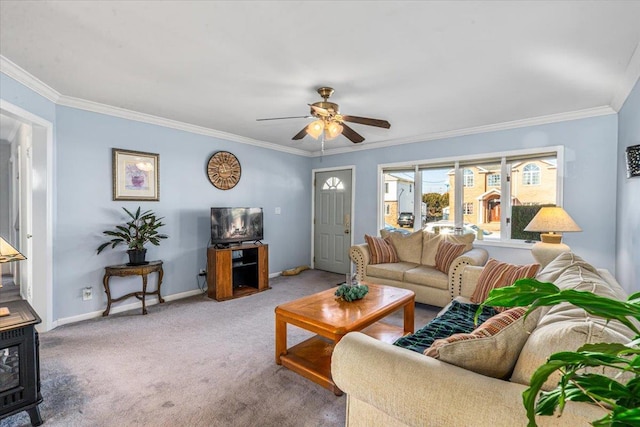 living room featuring ceiling fan, ornamental molding, and carpet