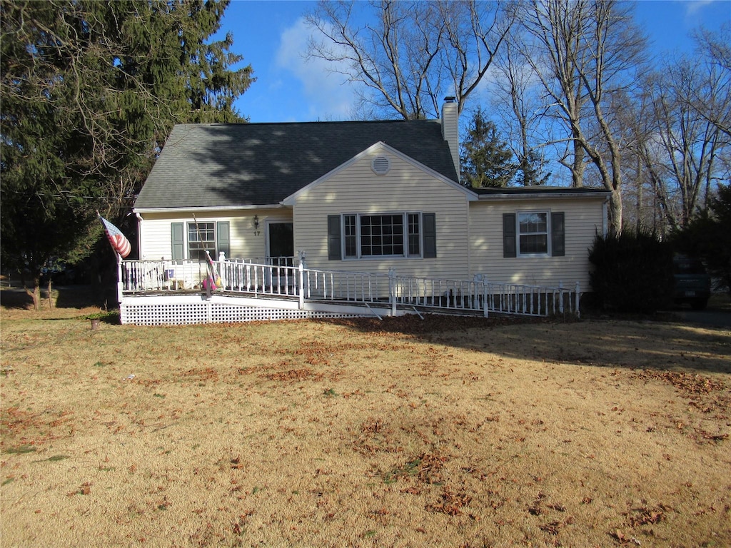 view of front of home featuring a front yard and a wooden deck