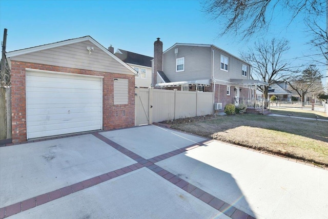 view of front facade with a front yard, a garage, and an outdoor structure