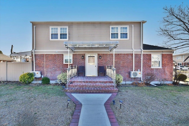 view of front facade with a front lawn, a pergola, and ac unit