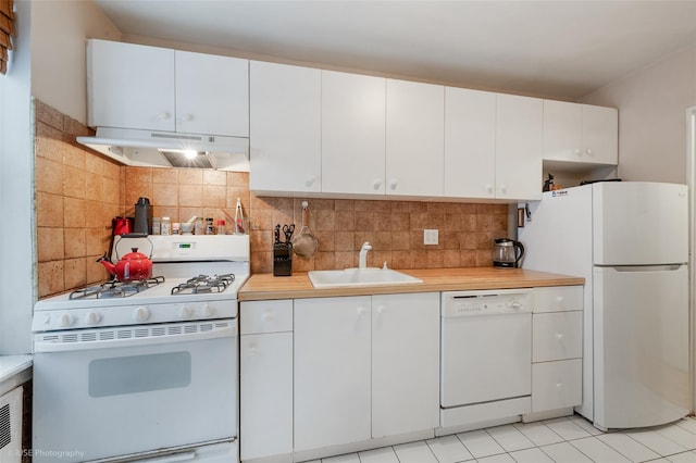 kitchen featuring sink, white appliances, and white cabinets