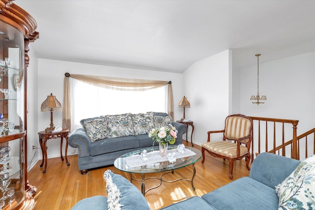 living room with vaulted ceiling and light wood-type flooring