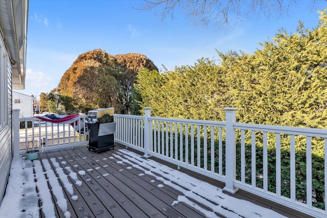 wooden deck with a grill