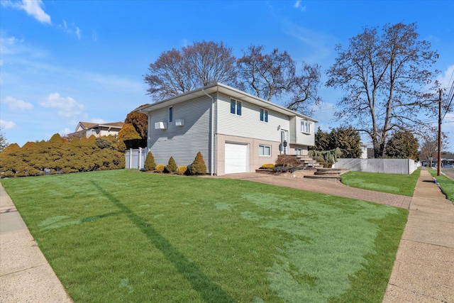 view of home's exterior featuring a garage and a yard