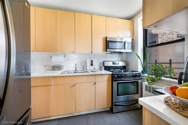 kitchen featuring sink, stainless steel appliances, and light brown cabinets