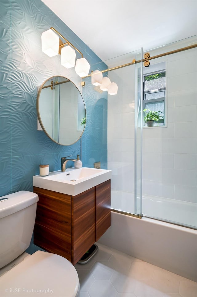 full bathroom featuring toilet, tile patterned floors, combined bath / shower with glass door, and vanity