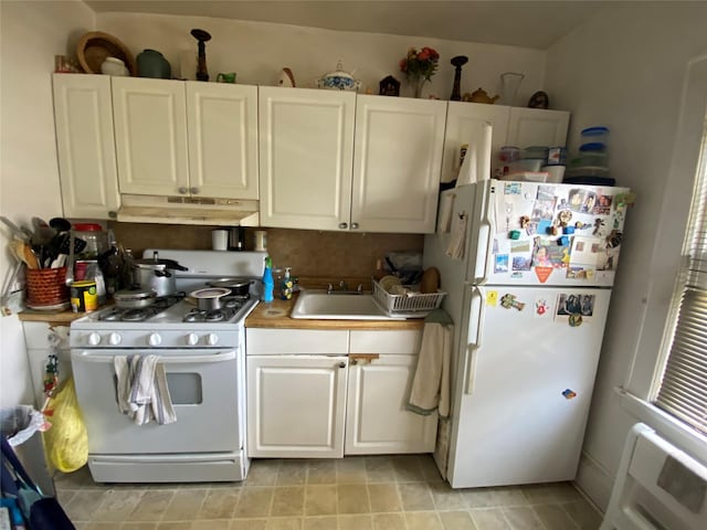 kitchen featuring sink, white appliances, and white cabinets