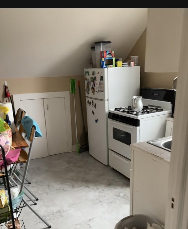 kitchen with white appliances and white cabinetry