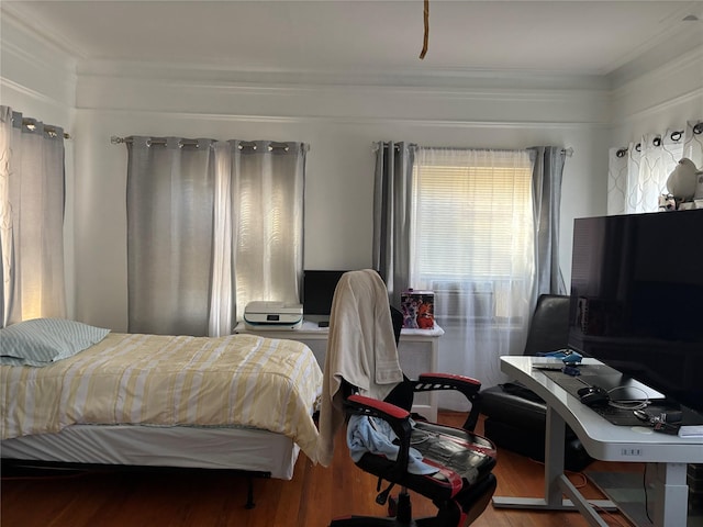 bedroom with hardwood / wood-style flooring, cooling unit, and ornamental molding