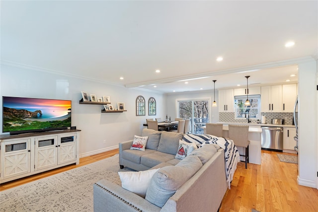 living room featuring ornamental molding and light wood-type flooring