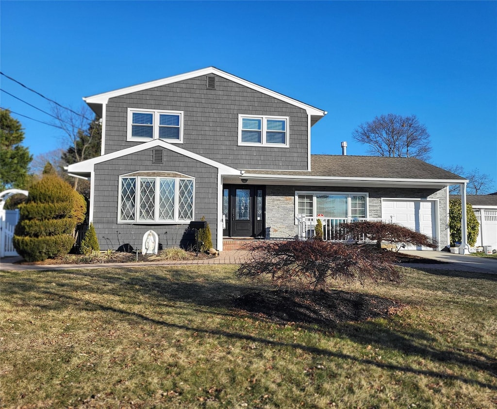 front facade featuring a garage and a front lawn