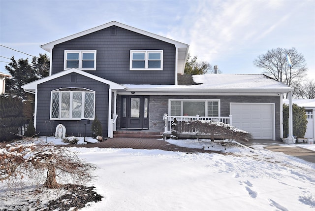 front of property featuring covered porch and a garage