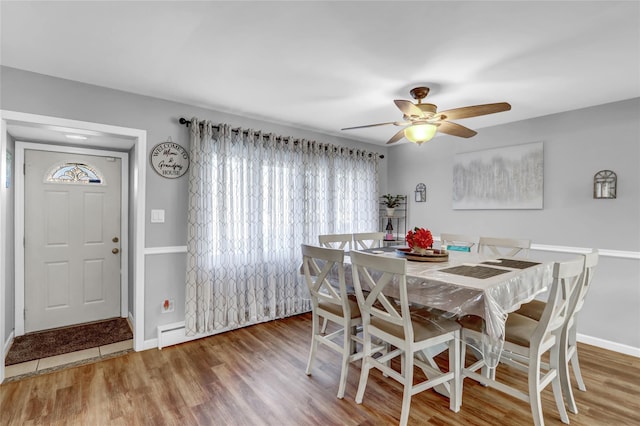 dining area featuring ceiling fan and wood-type flooring