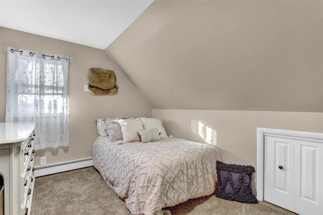 carpeted bedroom with baseboard heating and lofted ceiling