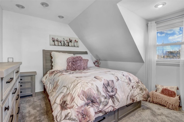 carpeted bedroom with lofted ceiling