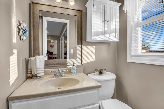 bathroom featuring toilet and vanity