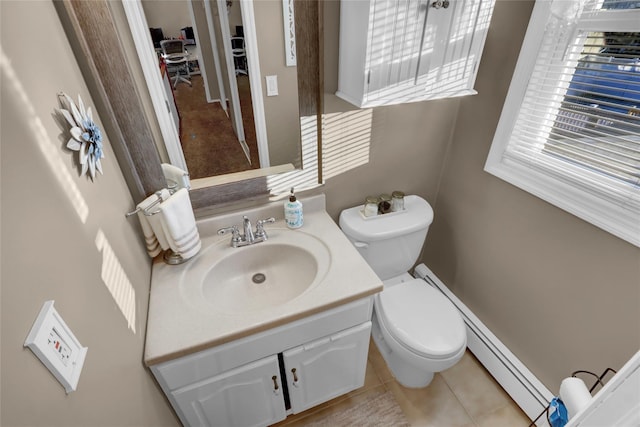 bathroom with baseboard heating, toilet, vanity, and tile patterned flooring