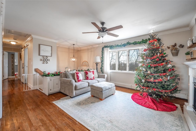 living room featuring hardwood / wood-style flooring, ceiling fan, and ornamental molding