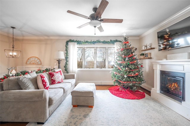 living room with ceiling fan with notable chandelier, ornamental molding, and hardwood / wood-style floors