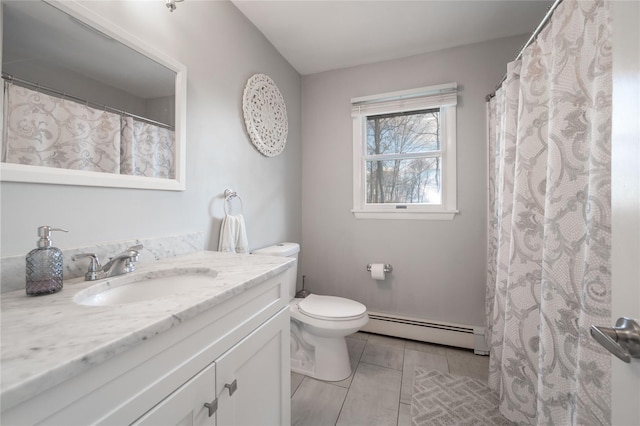 bathroom with toilet, vanity, and a baseboard heating unit